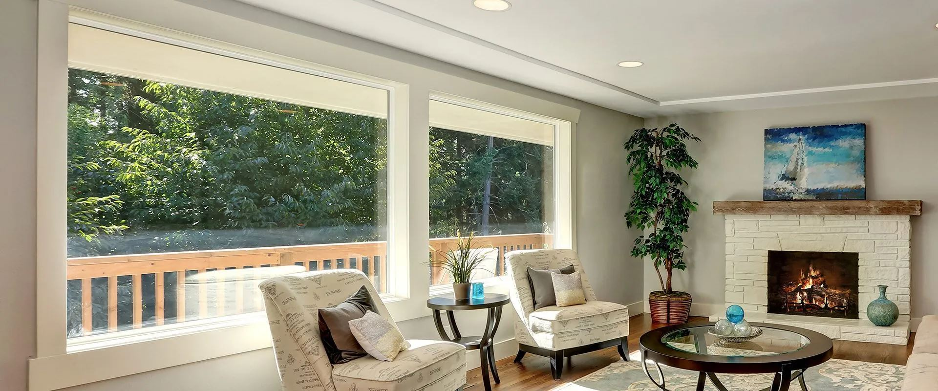 A living room showcasing a fireplace and a large window, enhancing the room's brightness and comfort.